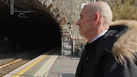 Old Man waiting for the train on the platform Stock Footage 173827186