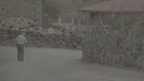 Old man walking away in a small town of Salamanca Spain. Stock Footage 170149148