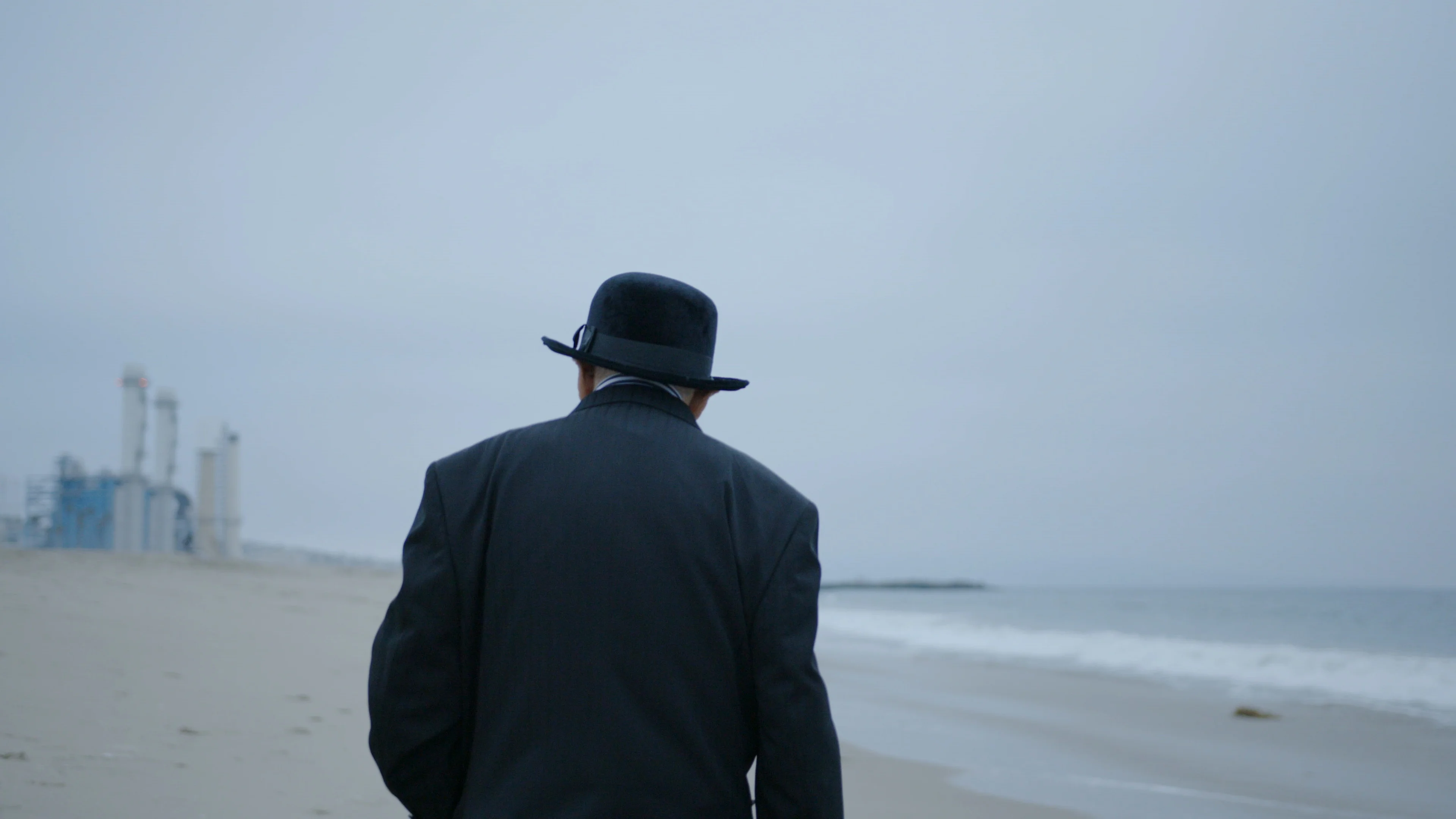 OLD MAN WALKING AT BEACH