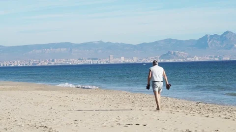 Old man walking on the beach nice bakground Stock Footage 89693054