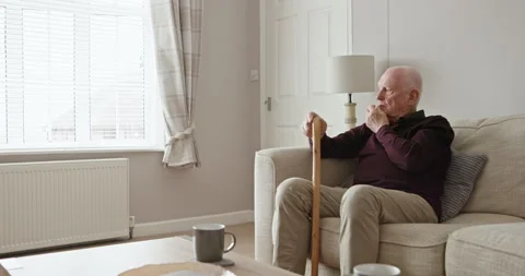 Old man, walking stick and thinking in home on sofa with alzheimer, dementia or Stock Footage 307809436