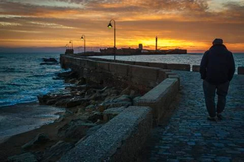 Old Man Walking at Sunset Stock Photos