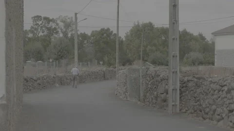 Old man walking through a town in Salamanca Spain. Stock Footage 170148908