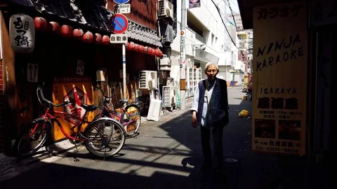 Old man walking towards camera in osaka Stock Footage 108905477