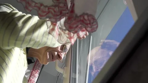 Old man waves hand looking outside plastic window and walks Video stock 134241013