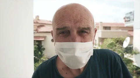 An old man wearing face mask and smiling. Protecting himself from coronavirus Stock Footage 132878652