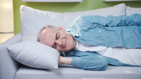 The old man who puts his head on the pillow remembers the past and gets sad. Stock Footage 237793765