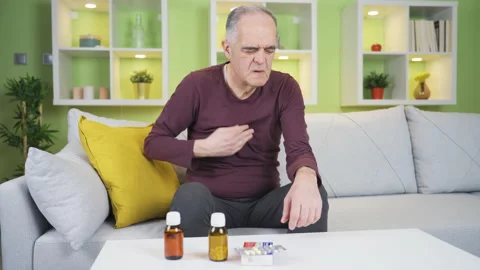 The old man, whose pulse has fallen, is having trouble breathing. Stock Footage 235443057