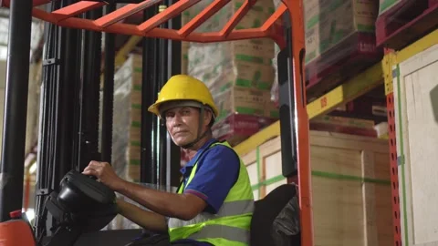 Old man worker drive forklift in big warehouse factory 動画素材 152922046