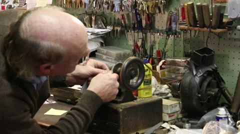 Old man working 1900 era keying machine in shop Stock Footage 45564150
