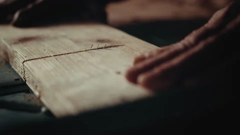 Old man working with a circular saw cutting a piece of wood in straight line Video stock 139756584