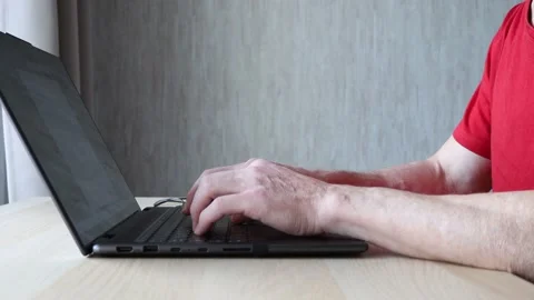 Old man working on computer. Senior man typing on laptop keyboard Stock Footage 239408475