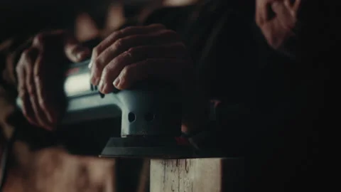 Old man working with sander on wood Stock Footage 139754895