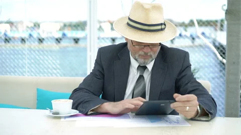 Old man working with tablet and writing down at the tablet . 4K Stock-Footage 66779774
