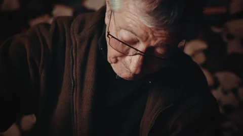 Old man working with a tool on wood in his cellar with a wooden wall 스톡 동영상 139754981