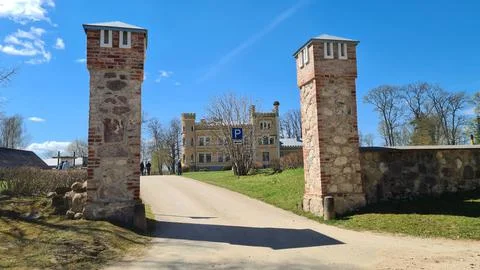 Old manor between stone pillars of the gate in the Latvian village of Garsene Foto stock