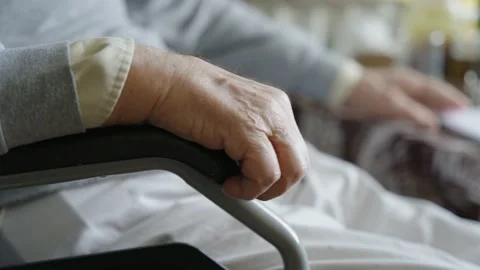 Old man's hand holding the armrest of a chair Stock Footage 237454574