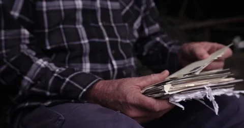 Old mans hands opening stack of letters and reading Stock Footage 122471232