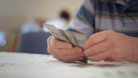 Old man's hands playing cards Stock-Footage 76558693