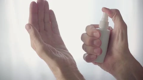 Old Man's Hands Use Hand Sanitizer Spray. Measures to Prevent Spread of Virus Stock Footage 144834048