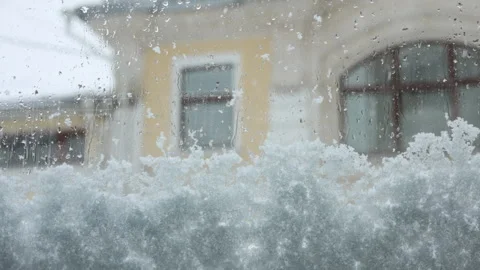 Old mansion, view from car window, snow outside, street, snowflakes Video stock 296773532