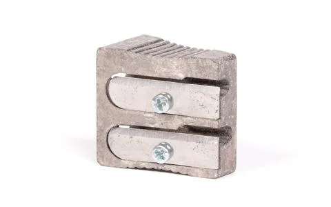 Old manual metal pencil sharpner on white background 库存照片