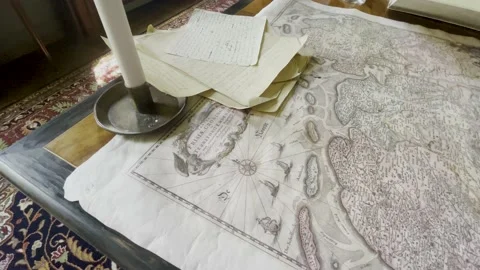 An old map with yellowed paper and a candle on top Stock Footage 232496198
