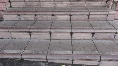 Old maroon stone steps covered with graphite with scratches Stock Photos