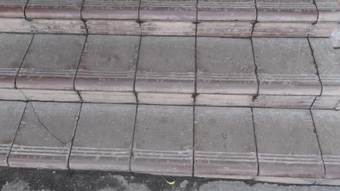 Old maroon stone steps covered with graphite with scratches Foto stock