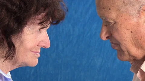 Old married couple looking each other: old woman nearly smiling Stock Footage 64305839