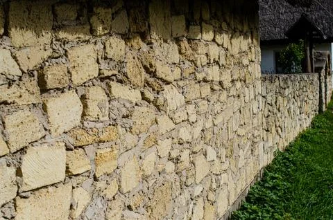 Old masonry of travertine at an angle to the observer Stock Photos