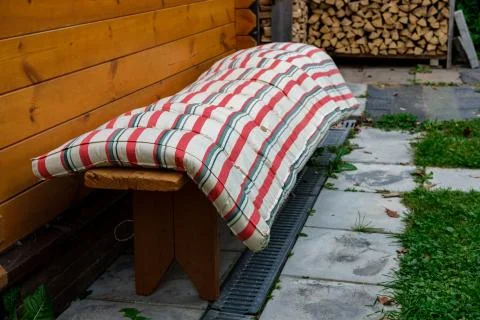 The old mattress is drying on the bench. Stock Photos