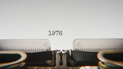 Old mechanical typewriter typing Year 1976 in a close-up view, with metal Stock Footage 321452831