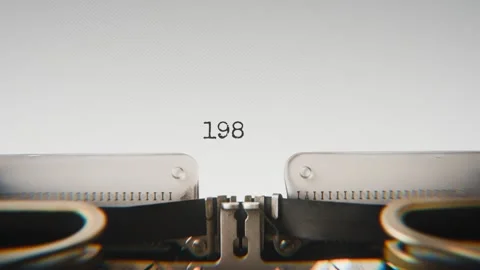 Old mechanical typewriter typing Year 1982 in a close-up view, with metal Stock Footage 321452880