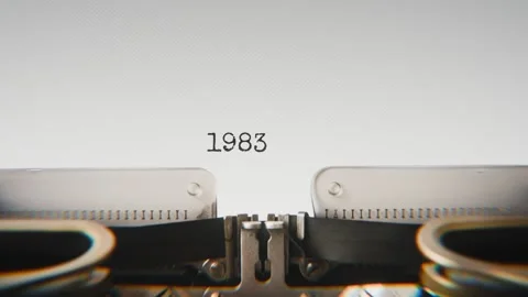 Old mechanical typewriter typing Year 1983 in a close-up view, with metal Stock Footage 321452904