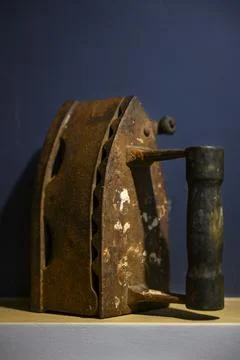 An old medieval iron with traces of rust in a blue niche in the wall Stock Photos