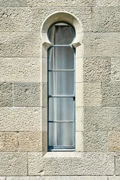 Old medieval window surrounded by stone wall in castle Stock Photos