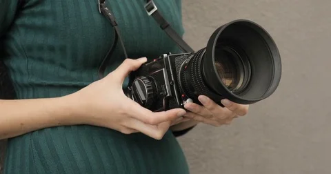 Old medium format camera in the hands of a hipster girl, close-up, film camera Stock Footage 75485990