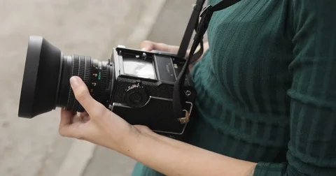 Old medium format camera in the hands of a hipster girl, close-up, film camera Stock-Footage 75582069