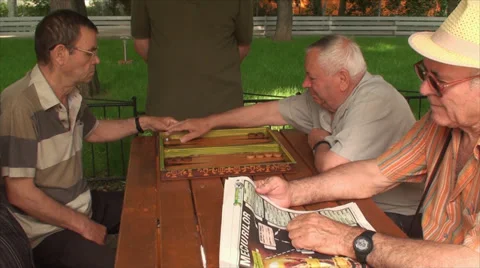 Old Men Playing Backgammon, Elderly, Retired, Park, Games, Paper News Stock Footage 39560028