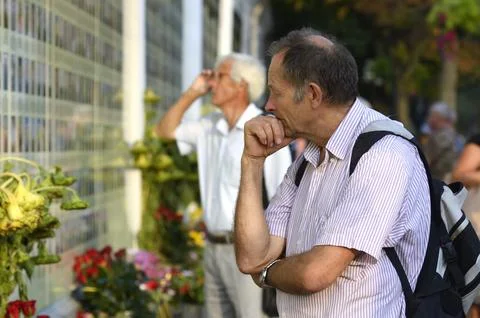 Old men standing in front of the Wall of Remembrance put flowers. Meeting Stock Photos