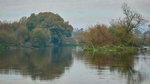 Old metal bridge over a small beautiful river. Autumn warm nature. Stock Footage 183377908