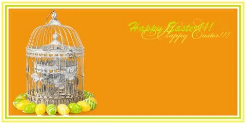 Old metal cage with easter eggs on orange background. Stock Photos