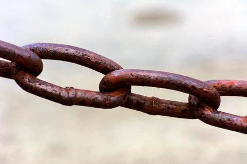 Old metal chain on a light background in sunlight Stock Photos