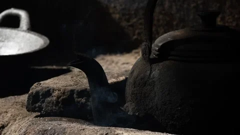 Old metal colored kettle with boiling water on a stove Stock Footage 143004293