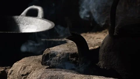 Old metal colored kettle with boiling water on a stove Stock Footage 143004337