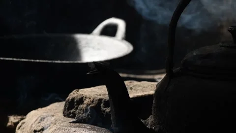 Old metal colored kettle with boiling water on a stove Stock Footage 143004352