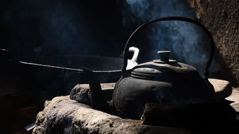 Old metal colored kettle with boiling water on a stove Stock Footage 143004554