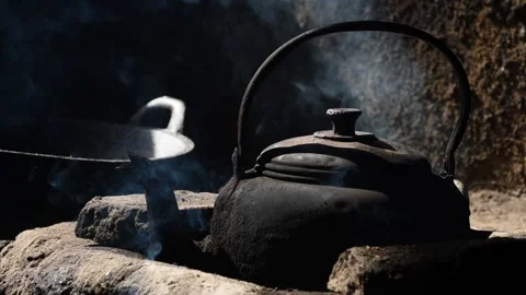 Old metal colored kettle with boiling water on a stove Stock Footage 143004556