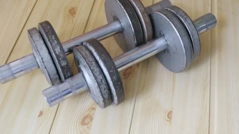 Old metal dumbbells roll up to camera and invite you to train. Stock Footage 287315819